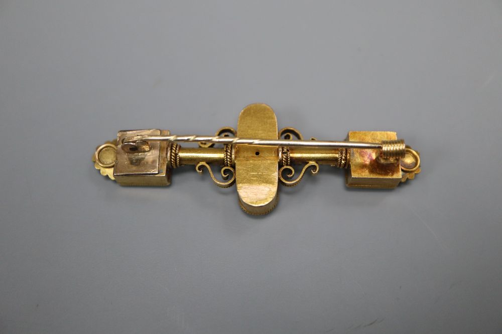 A Victorian Etruscan style gold filigree work brooch, set with pearls and amethysts, 57mm, gross 8 grams.